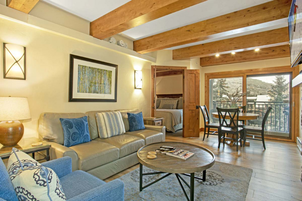 View of living room, dining room, entryway to bedroom of condo 602 Antlers at vail