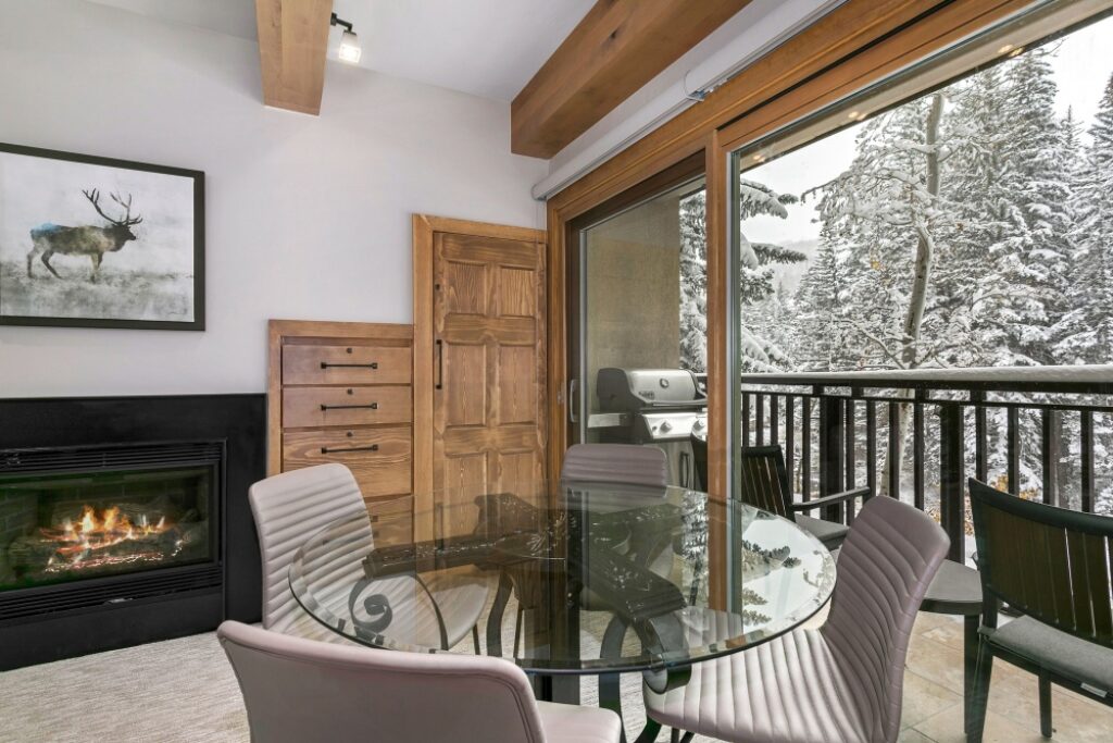 View of dining area, fireplace and balcony for condo 105 Antlers at Vail