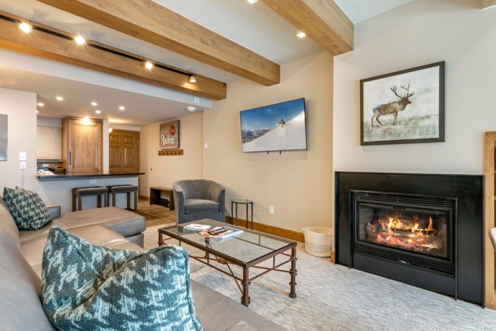 View of the living room, entryway and fireplace of condo 105 Antlers at Vail