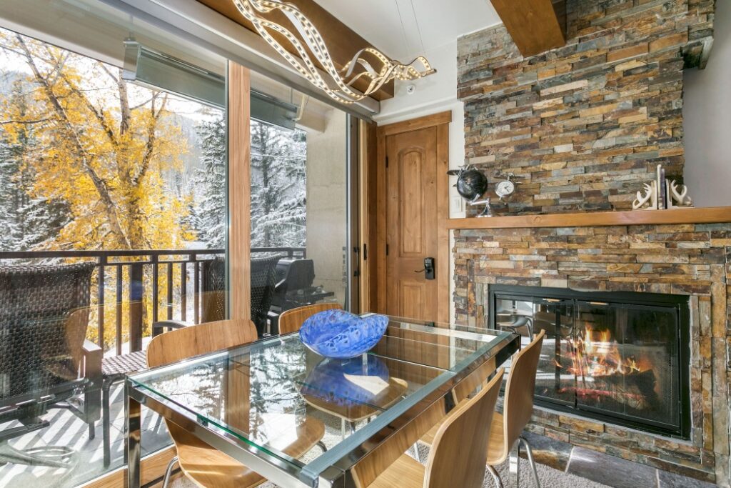 View of dining table, balcony, fireplace condo 106 Antlers at Vail