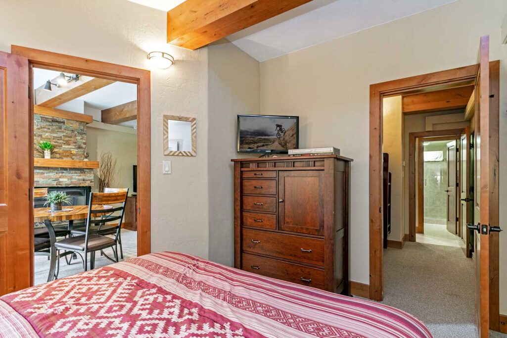 View of bedroom, dining area, hallway to bunk bed and bathroom area unit 108 Antlers at Vail