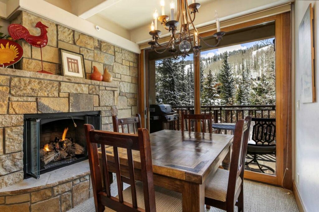 View of fireplace and dining room condo 111 Antlers at Vail