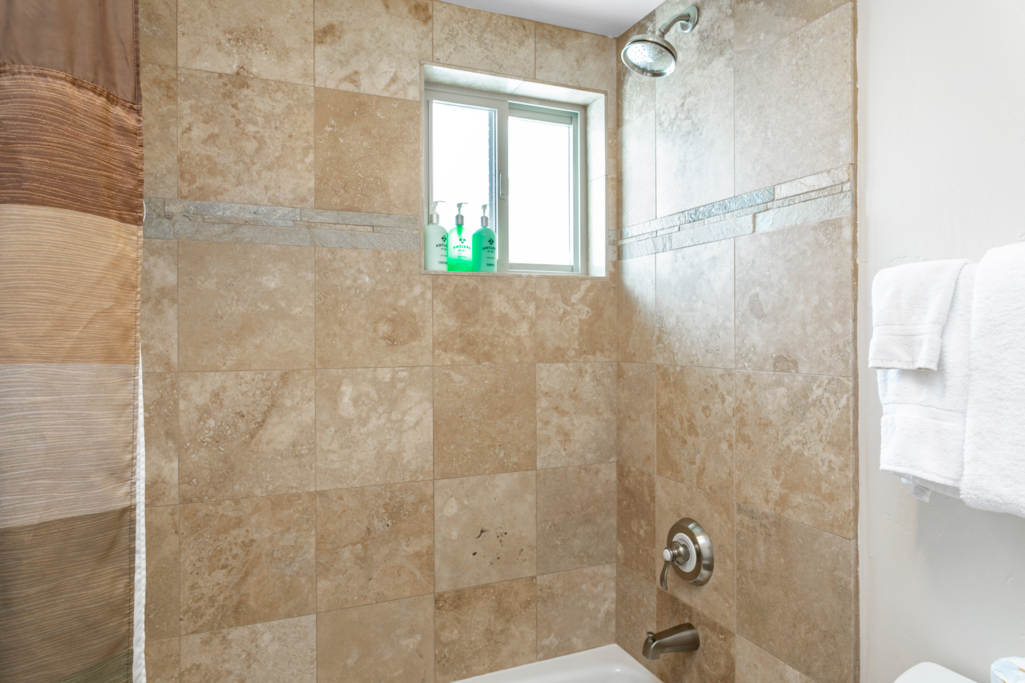 Bathroom shower and bath in condo 605