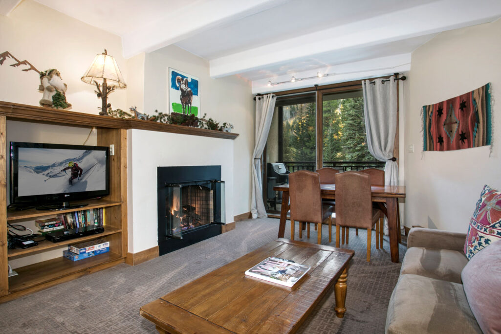 View of living room, dining area and fireplace in condo 203 Antlers at Vail