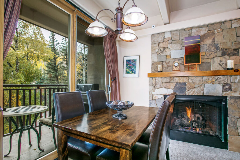 View of dining area, fireplace and balcony condo 206 Antlers at Vail