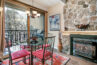 dining area of Antlers at Vail condo 308, with gas fireplace and large windows to the river