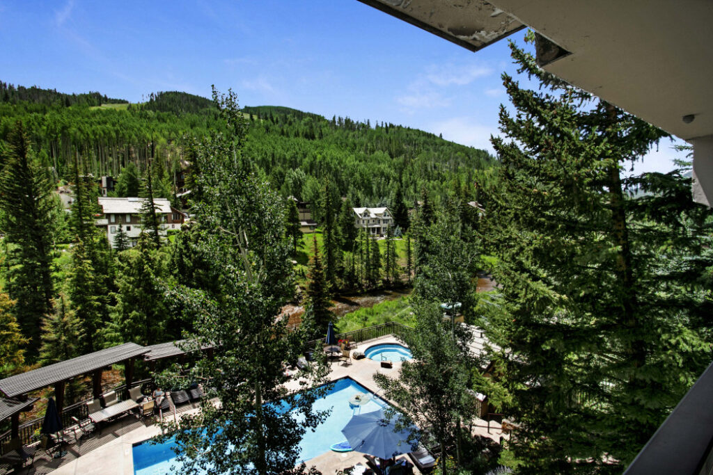 View of Gore Creek and Antlers pool from balcony of condo 311 Antlers at Vail