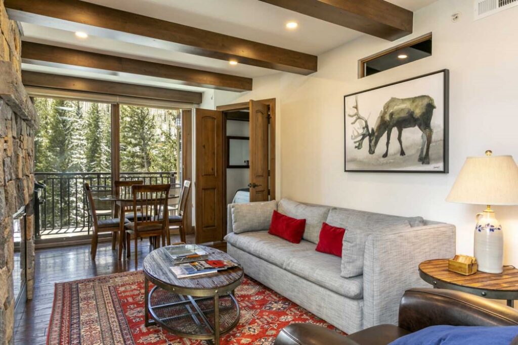Living room and dining room of Antlers at Vail condo 403 with cozy gas fireplace