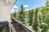 View of the green trees and ski slopes and the rushing river from the balcony of Antlers at Vail condo 407