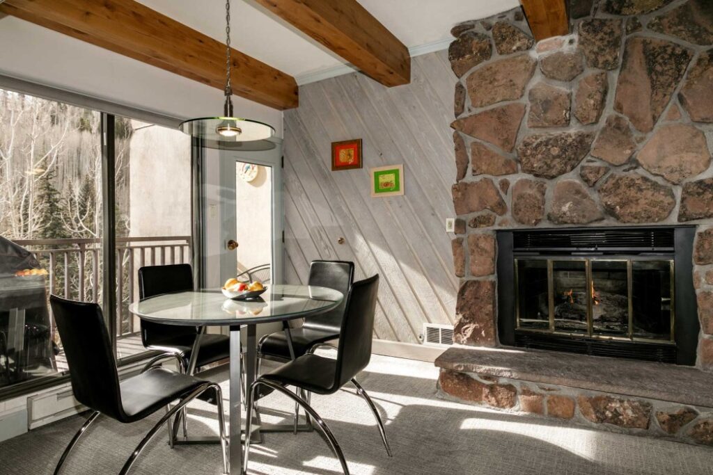 view of fireplace and dining room area condo 408 Antlers at Vail