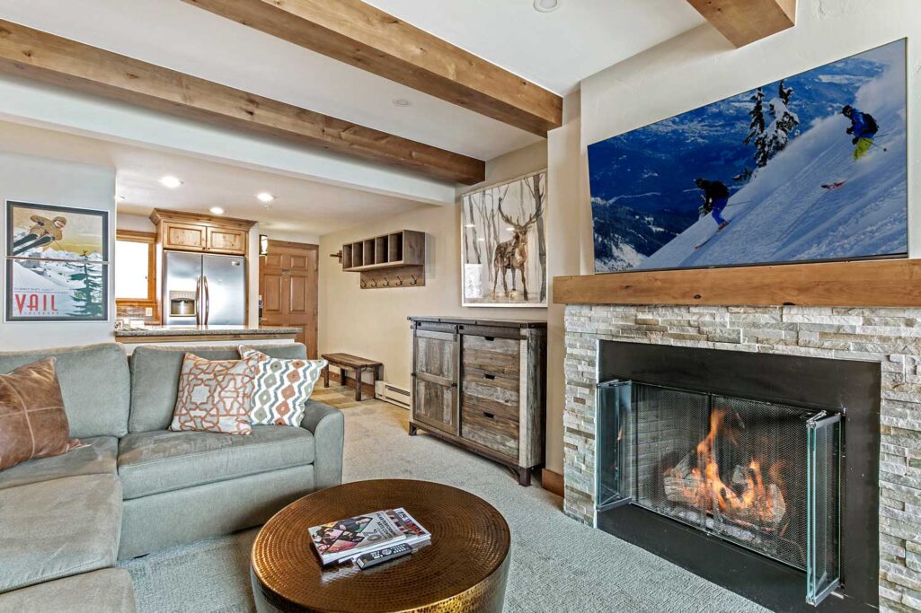 Living room of Antlers at Vail condominium 507 with a cozy fire in the gas fireplace