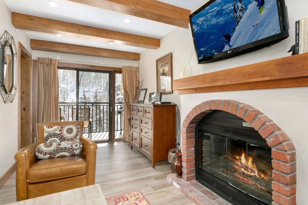 View of living room, fireplace and balcony condo 608 Antlers at Vail