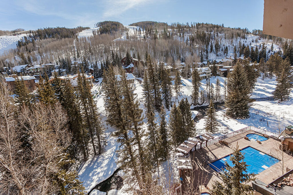 View of Vail Mountain and Gore creek and the pool from the balcony of 608 Antlers at Vail
