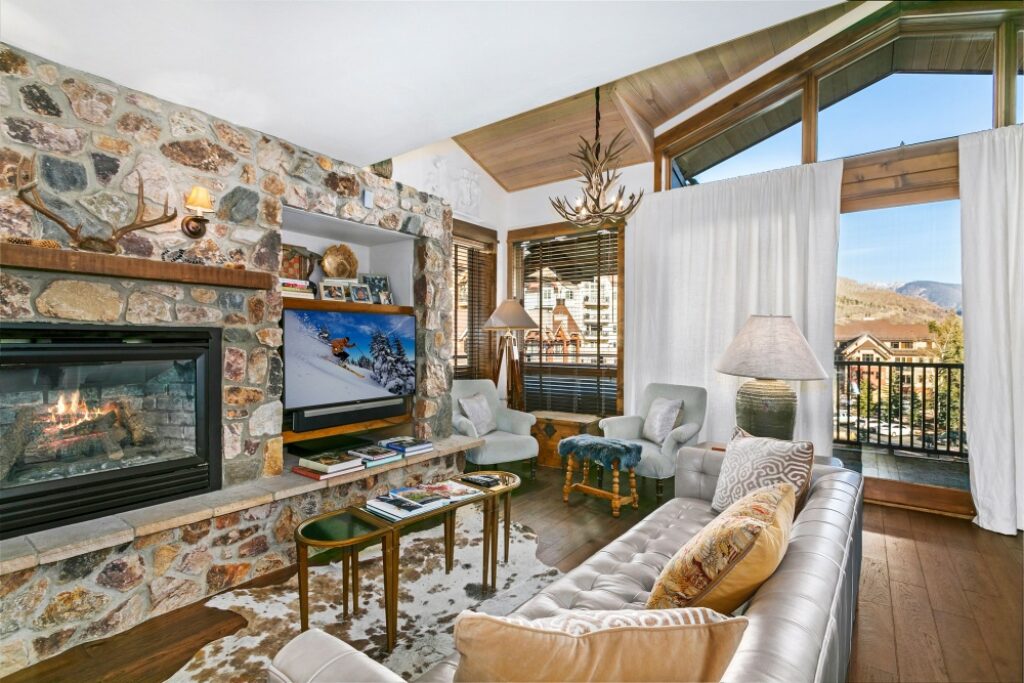 living room with warm gas fireplace in antlers at vail residence 620, with views of lionshead and the gore range