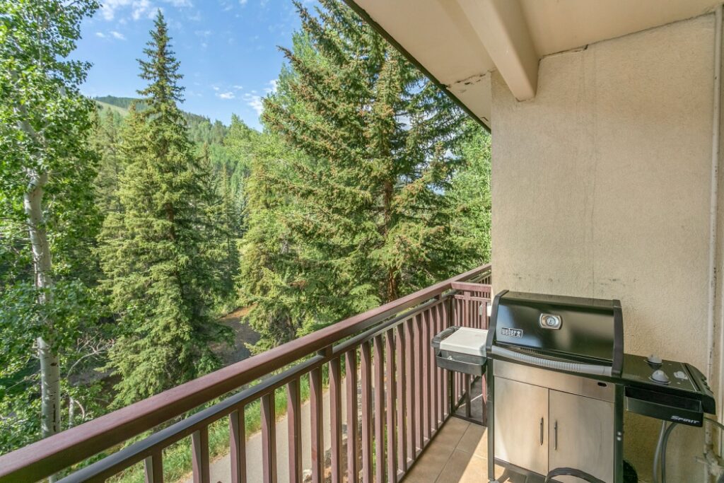 View of Gore Creek and the gas grill on balcony of condo 204 Antlers at Vail