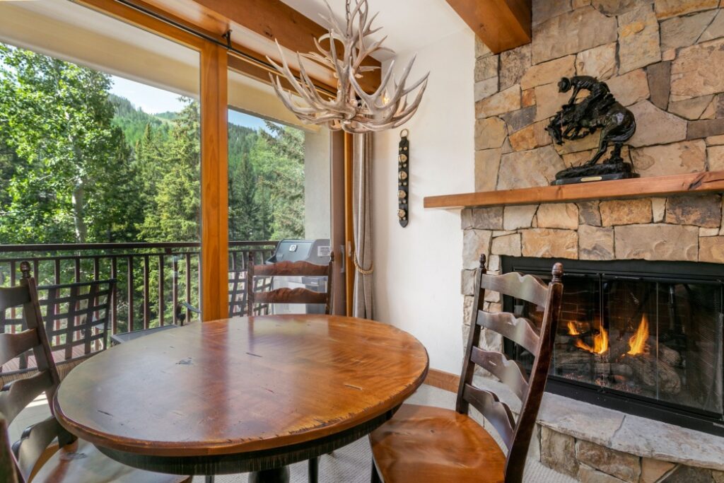 View of dining area, balcony and fireplace condo 204 Antlers at Vail