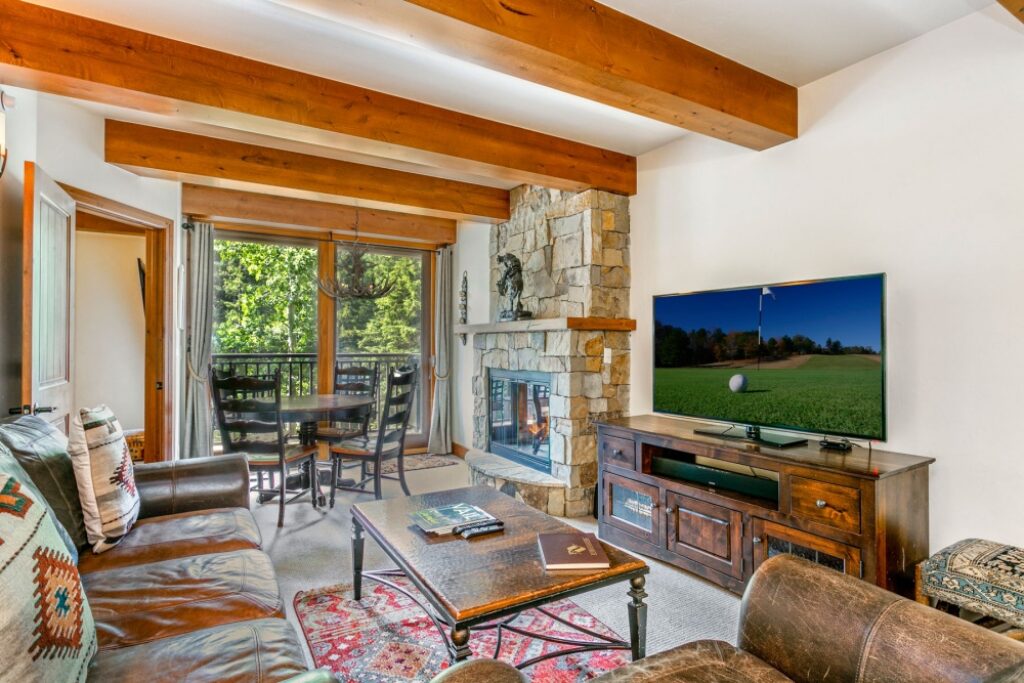 View of living room, dining area and fireplace of condo 204 Antlers at Vail