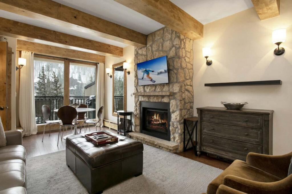 Living and dining area with large sliding glass doors to the balcony with mountain views from Antlers at Vail unit 508