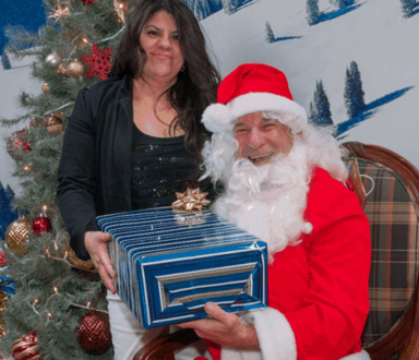 Housekeeper Belinda Enriquez receiving a gift from Santa
