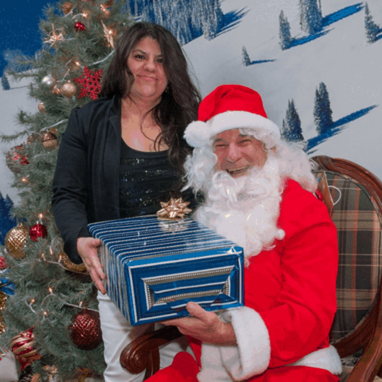 Housekeeper Belinda Enriquez receiving a gift from Santa