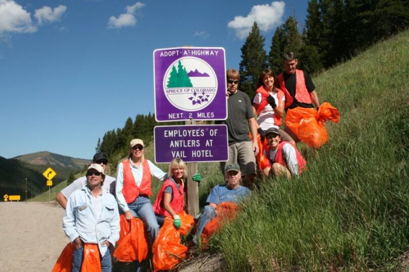 antlers employees by their adopt a highway sign