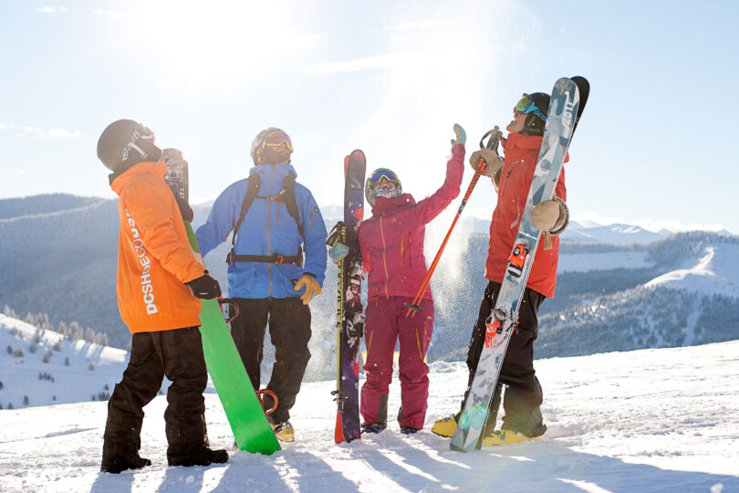 a group of skiers and snowboarders on vail mountain