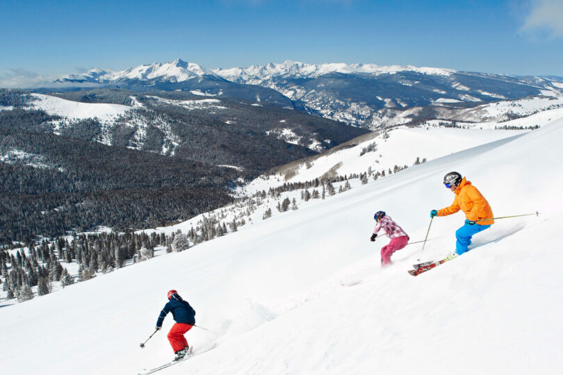 skiers on a back bowl on vail mountain
