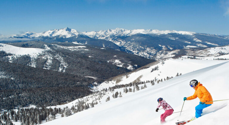 skiers on a back bowl on vail mountain