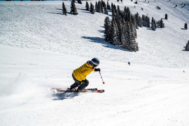 skier going down an open ski slope