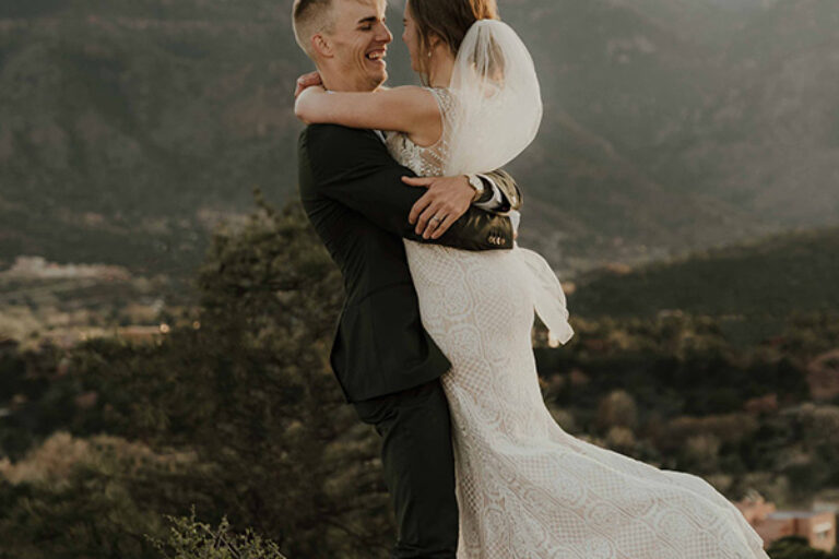 Man and Woman wedding portrait, hugging with mountain backdrop