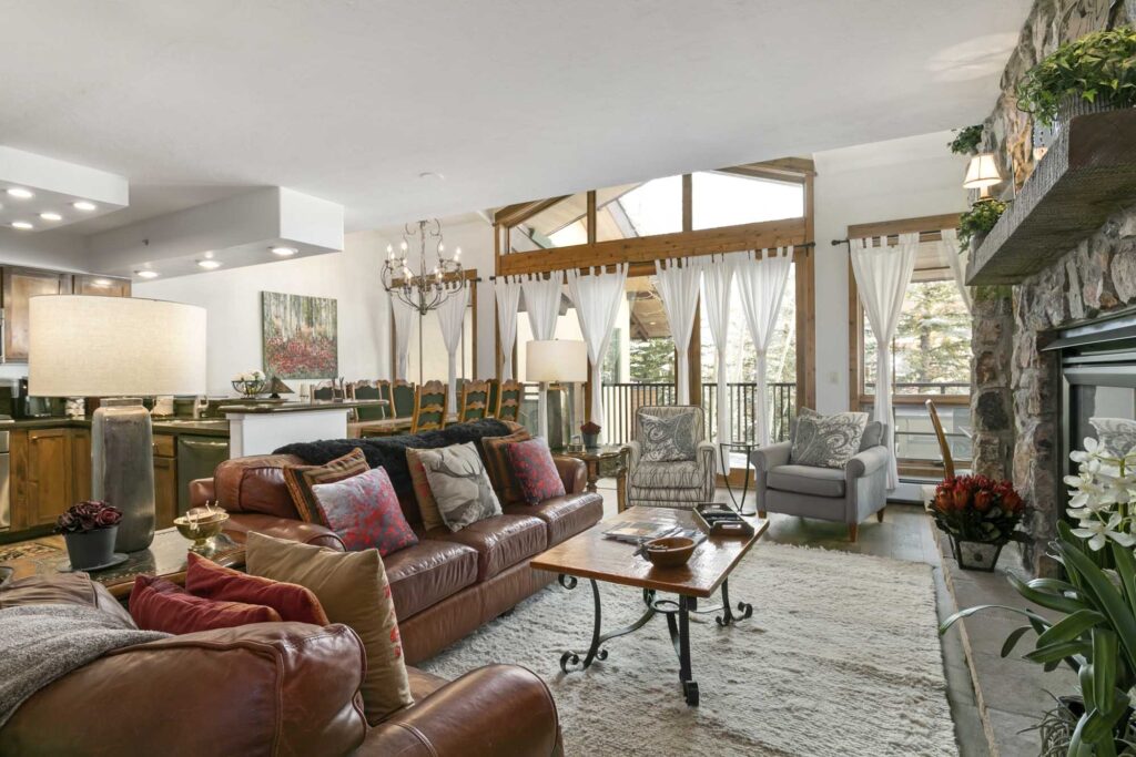 living room of antlers at vail residence 518, with large windows letting in natural light
