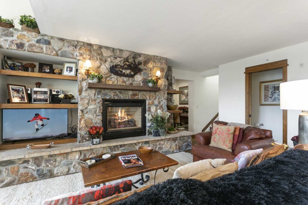 living room of antlers at vail residence 518, with cozy fireplace