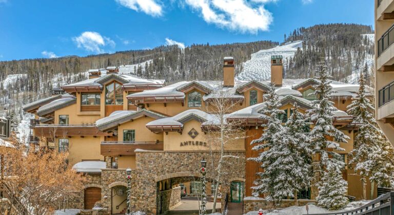 Antlers at Vail building with the ski slopes behind it