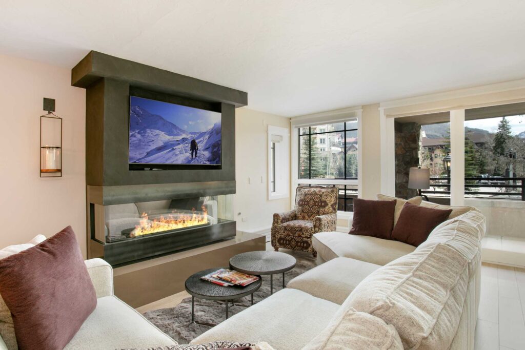 Bright living room of Antlers at Vail condo 321, with cozy gas fireplace