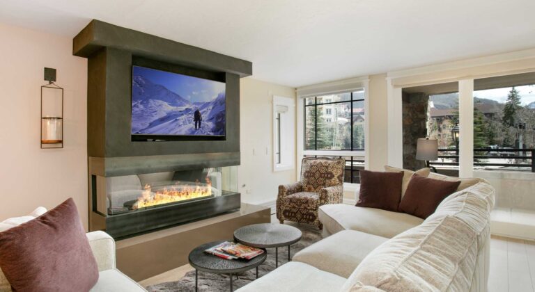 Bright living room of Antlers at Vail condo 321, with cozy gas fireplace