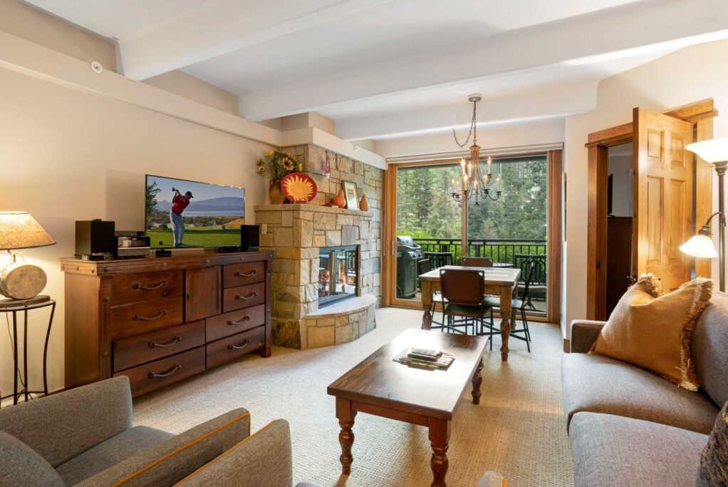 living area of Antlers at Vail unit 111 with windows to the creek outside