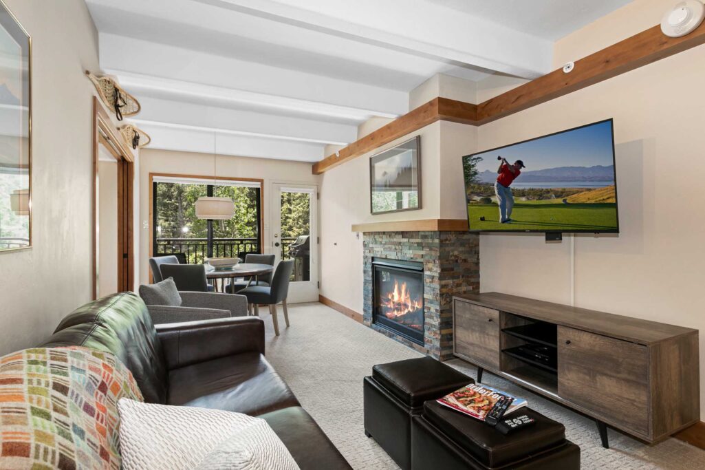 living and dining area of Antlers at Vail unit 304 with views of the creek below