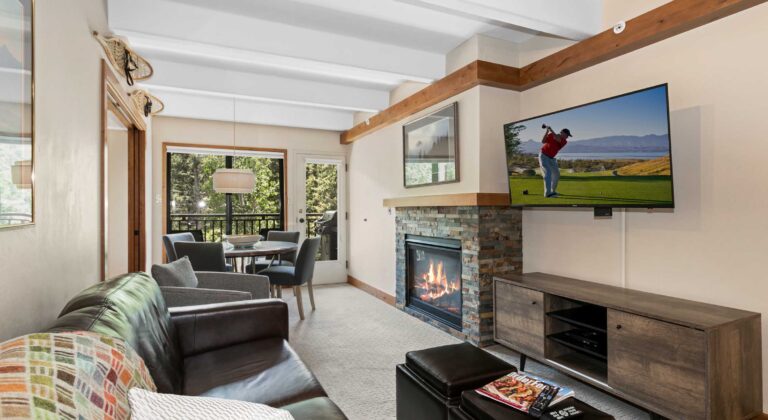 living and dining area of Antlers at Vail unit 304 with views of the creek below