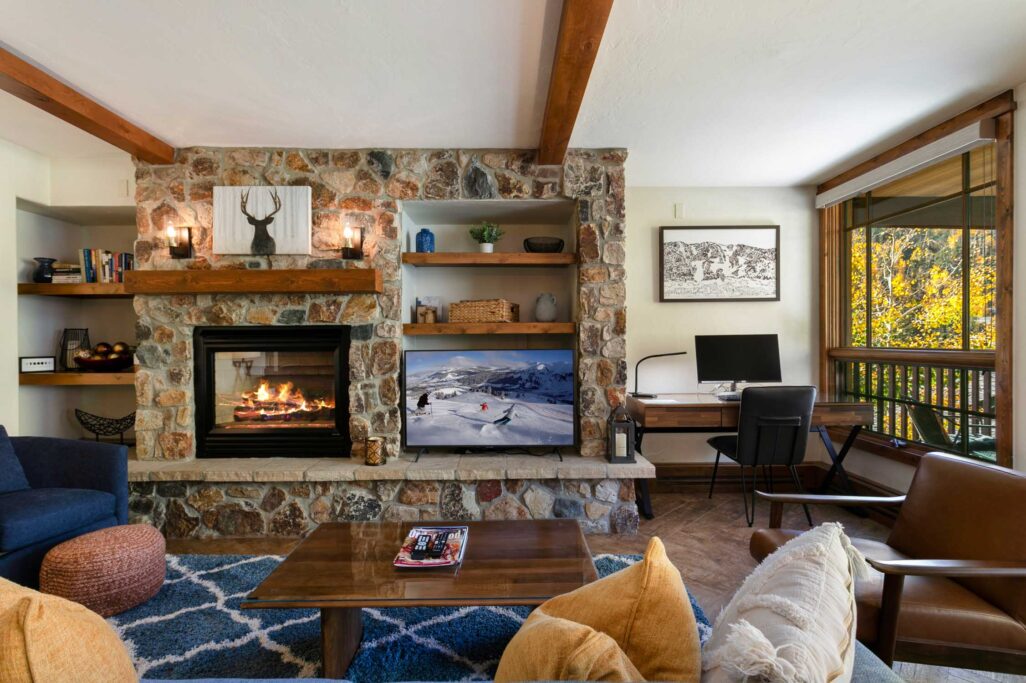 Living room with cozy fireplace of Antlers at Vail condo 414