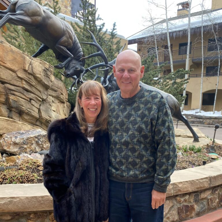 Antlers at Vail guests, John & Cynthia. in front of the elk statue in theAntlers at Vail courtyard