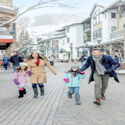 family enjoying town of vail in winter