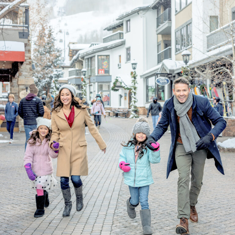 family enjoying town of vail in winter