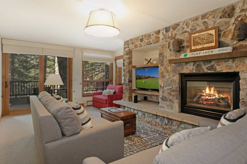 Antlers at Vail condo 316 living room with stone fireplace and mountain lodge décor