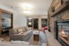Antlers at Vail condo 316 living room with stone fireplace and mountain lodge décor