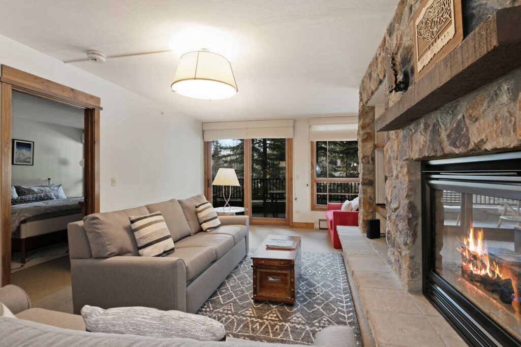 Antlers at Vail condo 316 living room with stone fireplace and mountain lodge décor