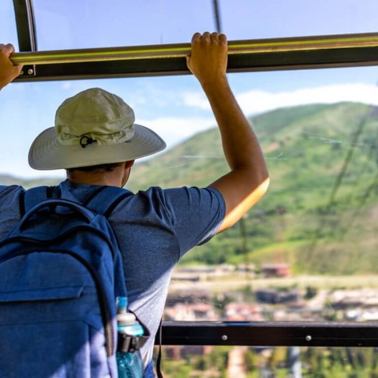 man in a gondola taking in the view